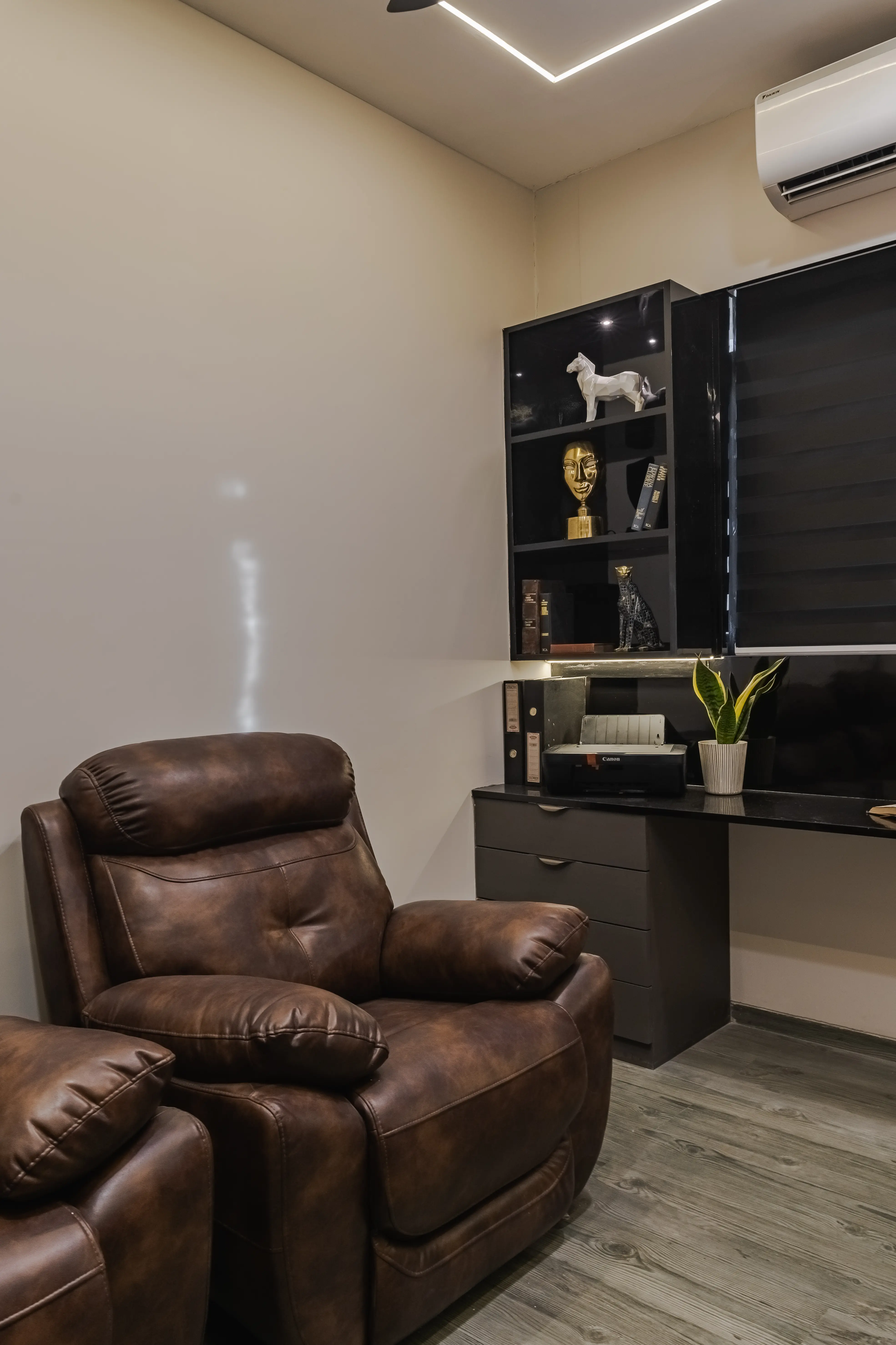 Cozy study retreat with a comfortable recliner and dedicated workspace, interior by Archnine Design Studio