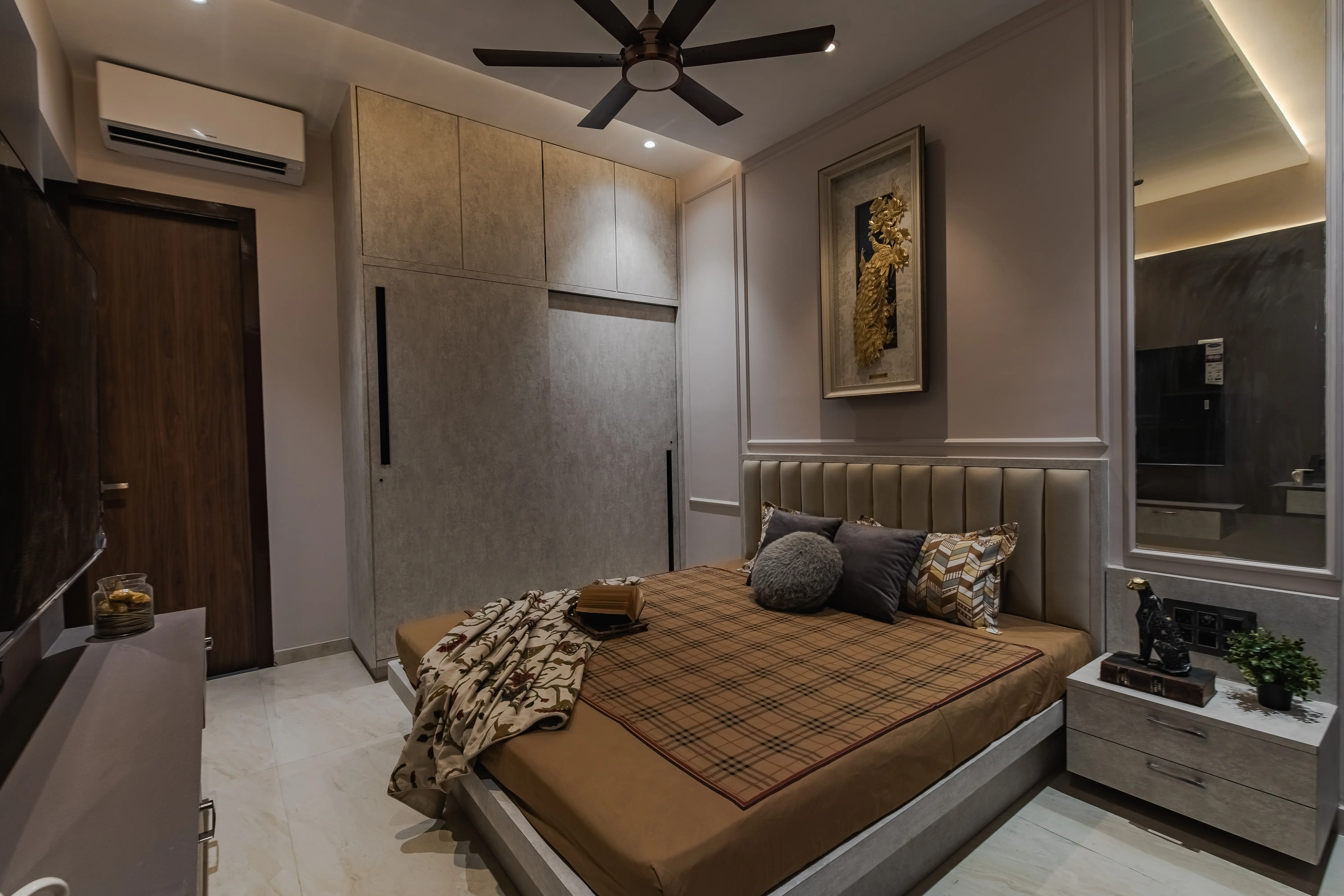 Bright bedroom interior with green pillow, white linens, and potted plant on wooden stool, interior by Archnine Design Studio