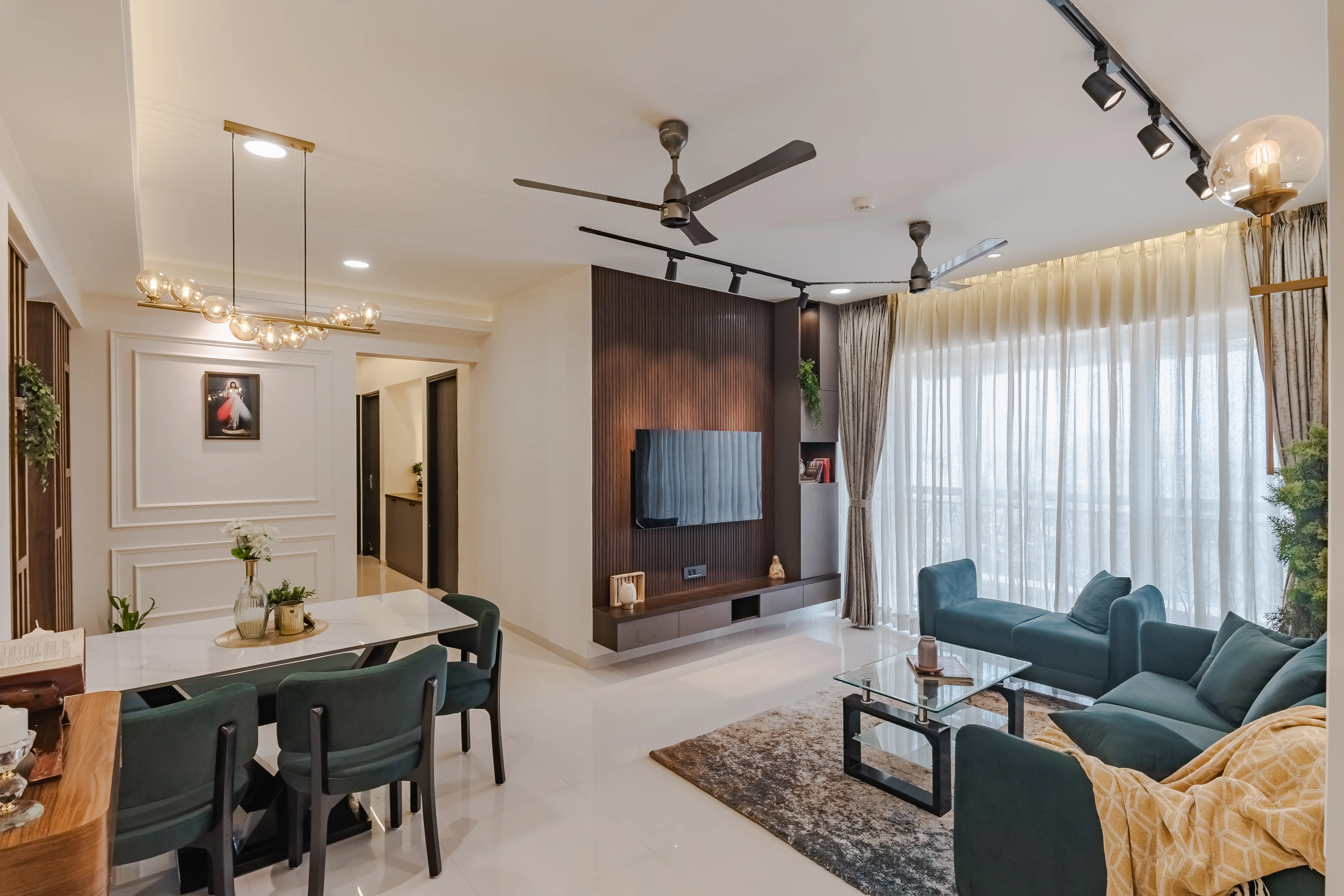 Modern living room in Kandivali features plush L-shaped sofa, round coffee table and patterned rug, interior by Archnine Design Studio